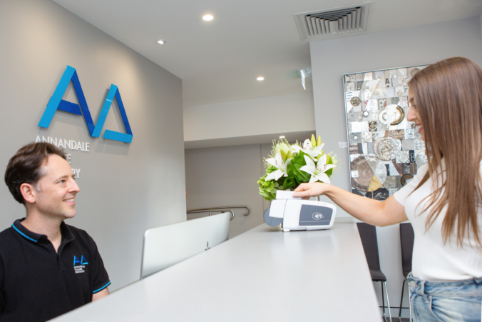 Dental clinic taking a payment at reception