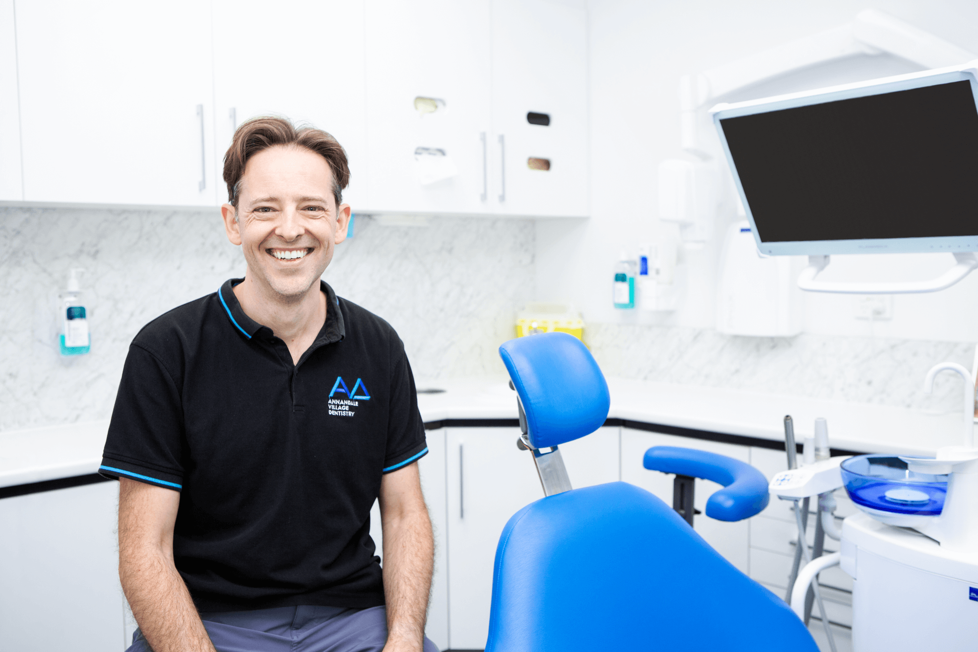 Tyro Health dentist sitting in a dental room smiling